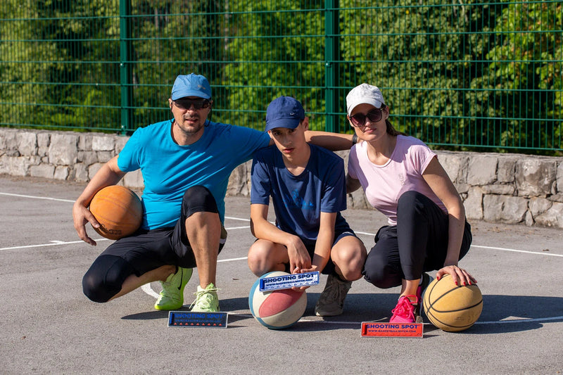 Basketball Witch Shooting Spot Markers used by family players on an outdoor basketball court for active basketball games and movement.